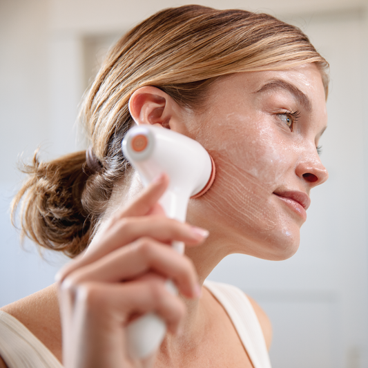 Woman washing face with Nu Skin ageLoc Lumispa